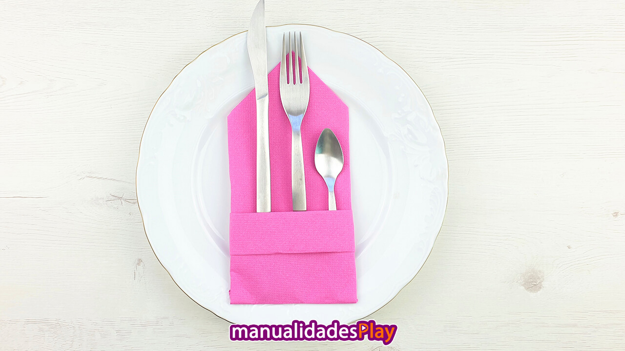 servilleta de papel rosa con cuchara, tenedor y cuchara en su interior